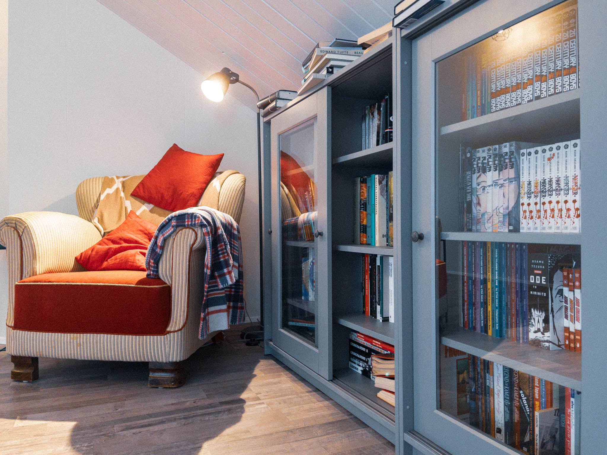 My reading corner at home. An old comfy chair. Bookcases. Books stacked