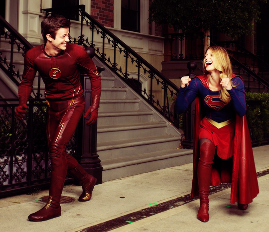 Flash and Supergirl, laughing